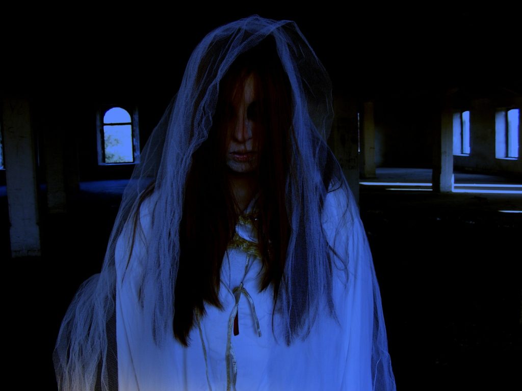 A spectral figure in a dim interior