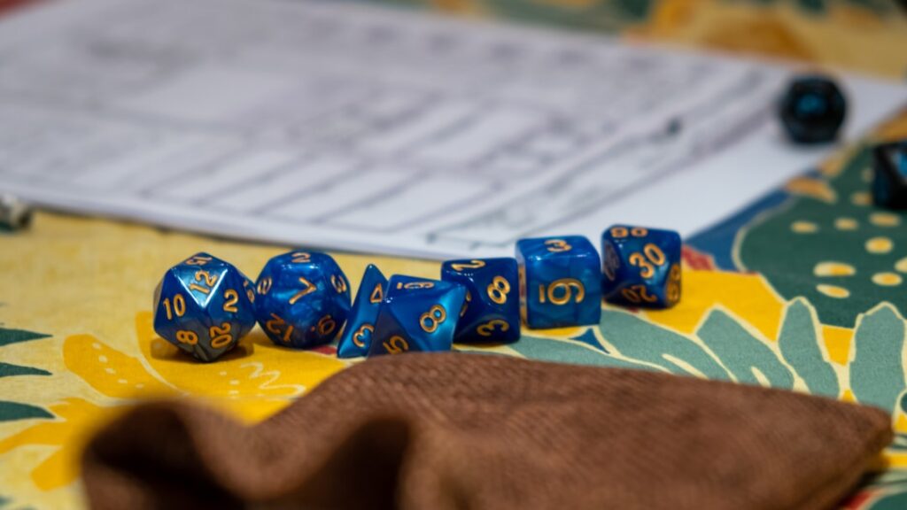 Dice, notes, and game pieces arranged for a tabletop roleplaying session