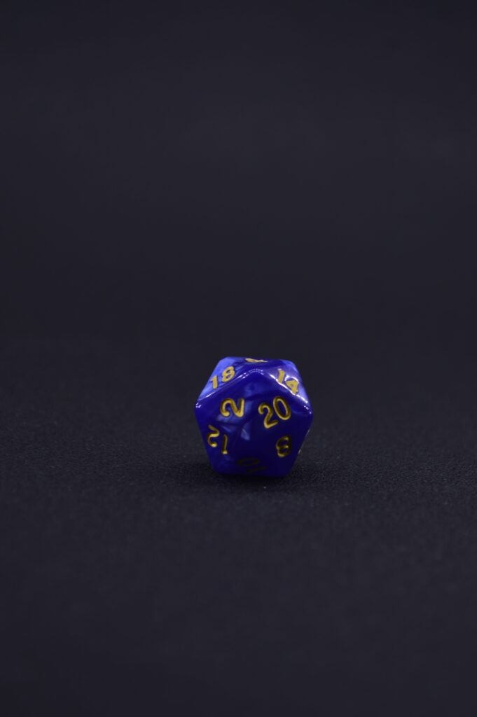 A twenty-sided die on a dark background, representing uncertainty and the authority of the dice in play.